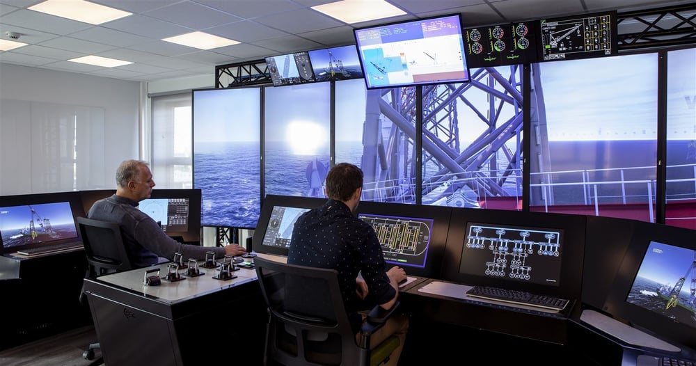 Operators at bridge and DP consoles in front of a wall of screens